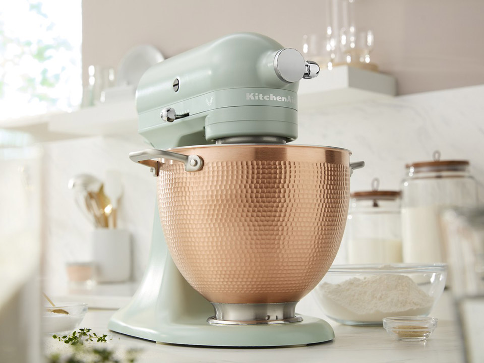 KitchenAid KSM180LELB Blossom tilt-head stand mixer in soft thyme green with its hammered copper bowl.